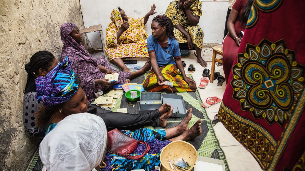 The collective of women against the illegal immigration of Thiaroye-sur-mer during a tontine [Max Hirzel/Al Jazeera]