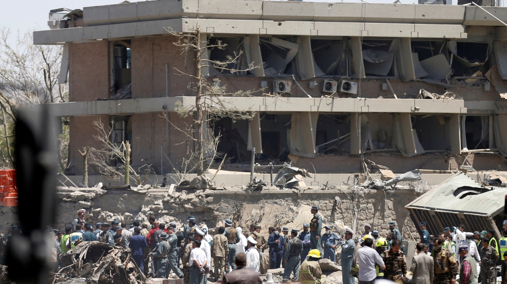 Afghan officials inspect the area outside the German embassy in Kabul after the blast [Mohammad Ismail/Reuters]