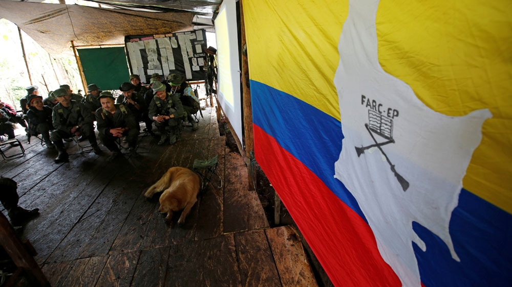 Members of the 51st Front of the FARC listen to a lecture on the peace process between the Colombian government and their force at a camp in La Cordillera Oriental, Colombia