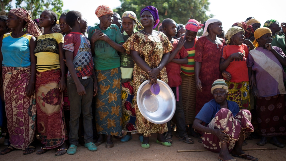 Women stand in line for food aid distribution in the village of Makunzi Wali