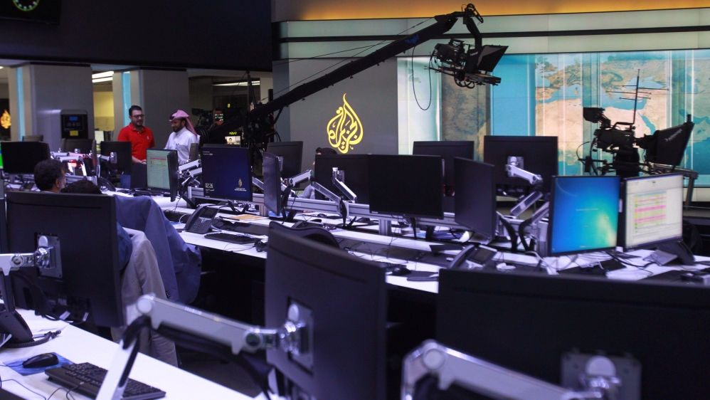Staff work inside Al Jazeera Media Network HQ in Doha