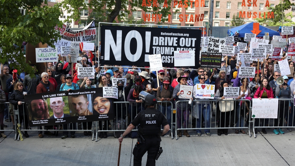 A police officer observes counter-protesters during an anti-Sharia rally in Seattle
