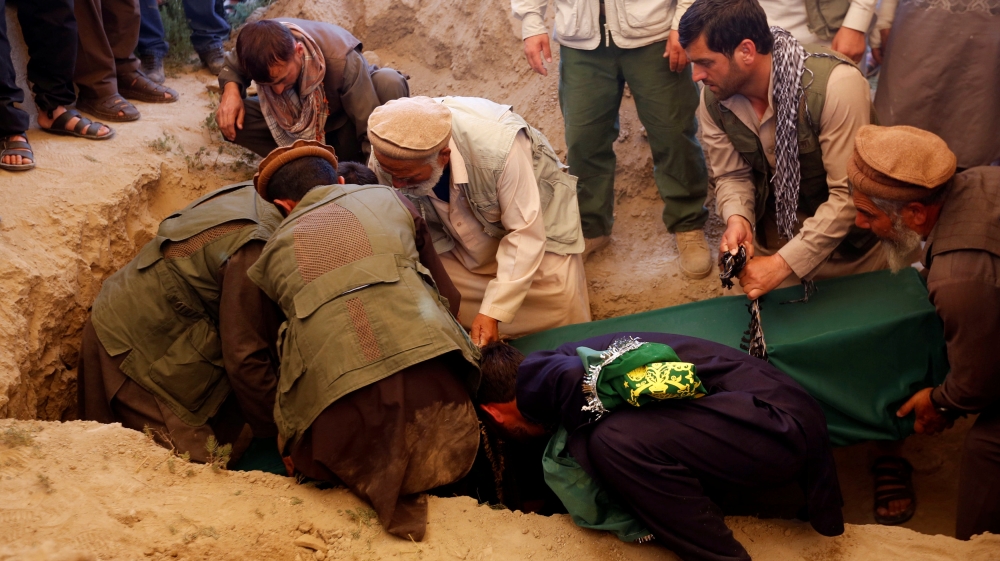 Relatives take part in a burial ceremony of one of the victims of Wednesday''s blast in Kabul, Afghanistan