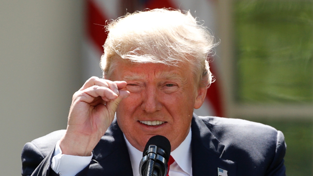FILE PHOTO: U.S. President Trump refers to temperature change as he announces decision to withdraw from Paris Climate Agreement at White House in Washington