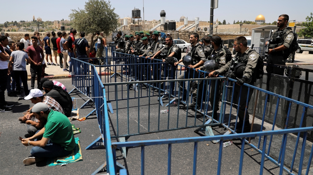 Israeli border police officers stand guard at a road block outside Jerusalem''s Old City
