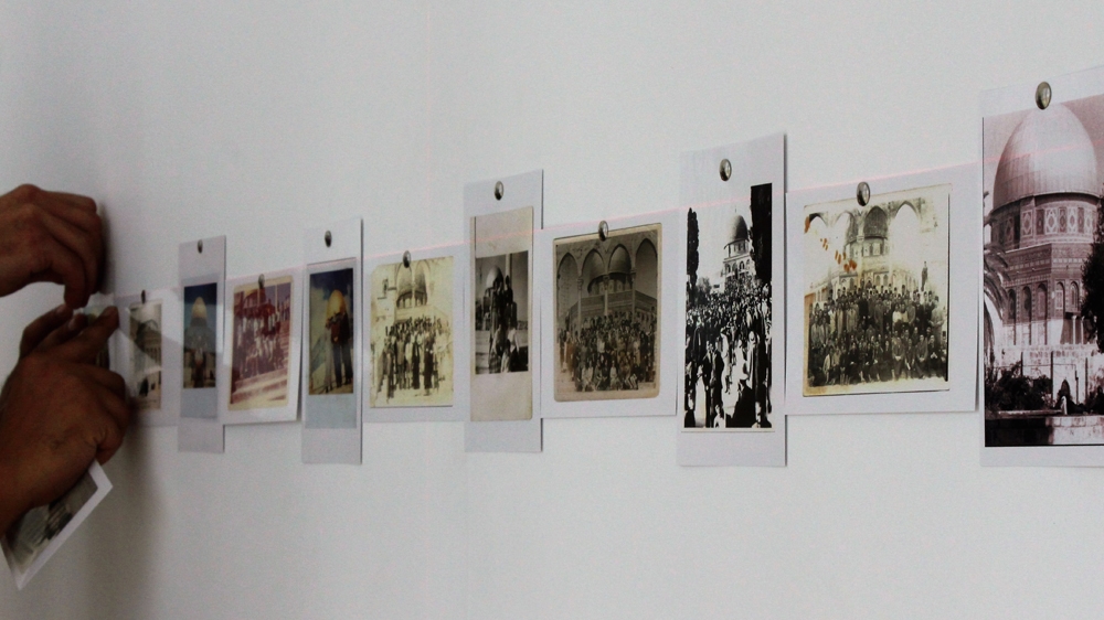 Various images of al-Haram al-Sharif and the Dome of the Rock line the hallway outside the Jerusalem Lives exhibition [Nigel Wilson/Al Jazeera]