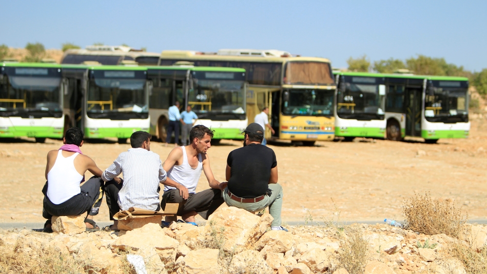 Bus drivers sit together in Jroud Arsal, near Syria-Lebanon border
