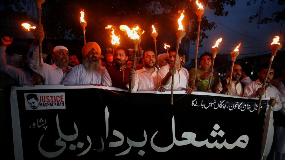 Protesters hold lamps to condemn the killing of Abdul Wali Khan university student Mashal Khan, after he was accused of blasphemy, during a protest in Peshawar