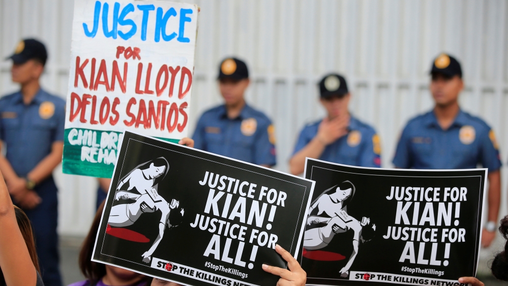 People attend a protest at PNP headquarters in Quezon city, Metro Manila