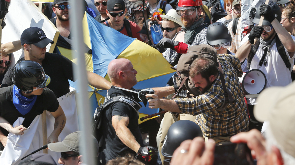 White nationalist demonstrators clash with counterdemonstrators at the entrance to ‘Unite the Right’ protest