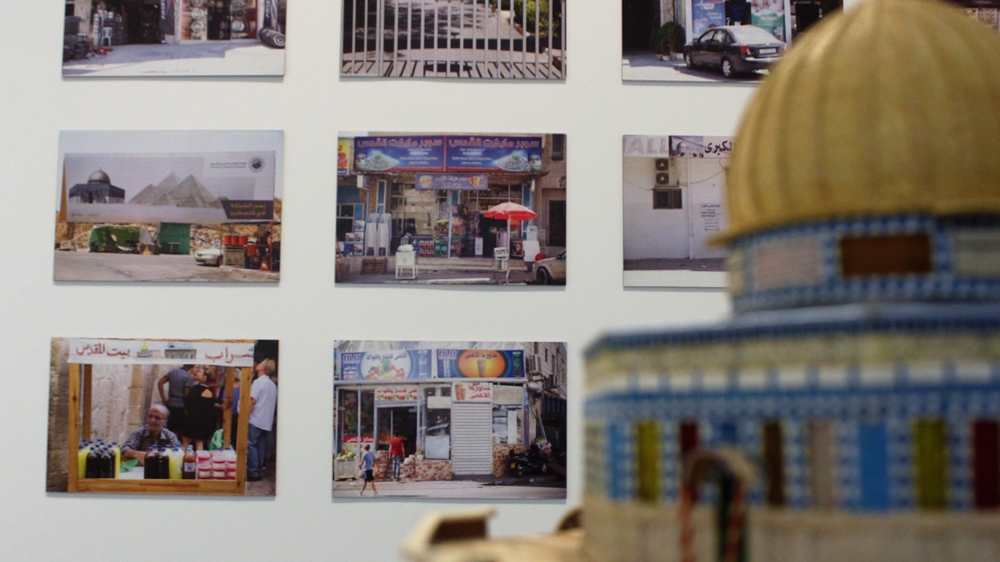 Photographs by Ahed Izhiman are displayed in the first room of the exhibition, surrounded by images, sculptures and souvenirs depicting the Dome of the Rock [Nigel Wilson/Al Jazeera]