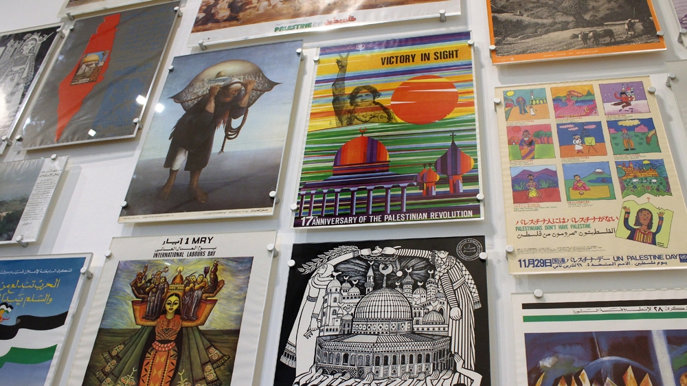 A selection of posters from the Palestinian Poster Project are arranged on one wall of the exhibition [Nigel Wilson/Al Jazeera]