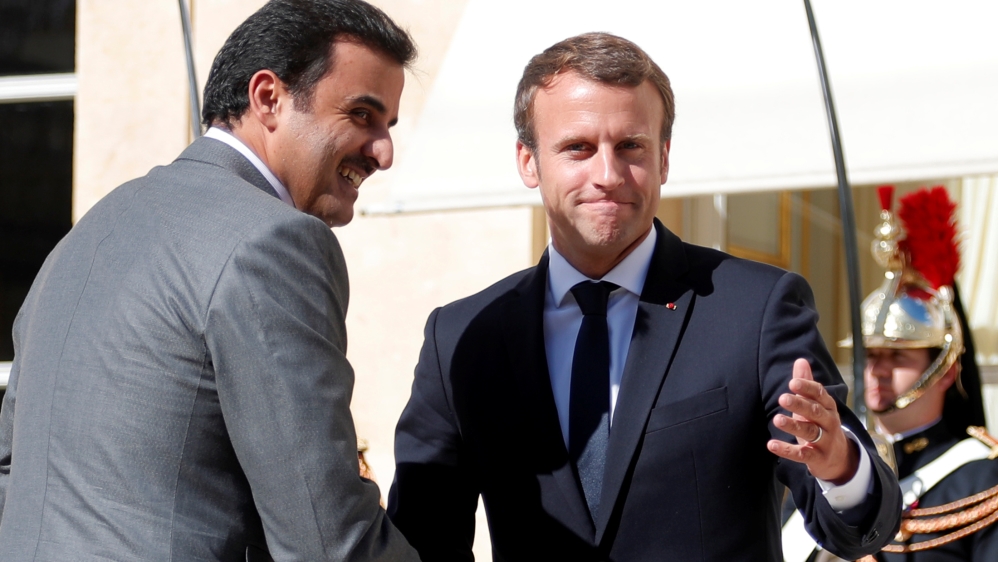 French President Emmanuel Macron greets Qatar Emir Sheikh Tamim bin Hamad al-Thani at the Elysee Place in Paris
