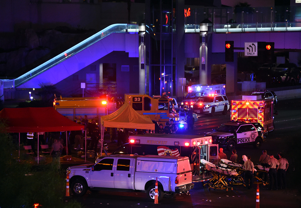 Police and rescue personnel gather at the intersection of Las Vegas Boulevard and Tropicana Ave. after a mass shooting at a country music festival nearby on October 2, 2017 in Las Vegas, Nevada. A gun