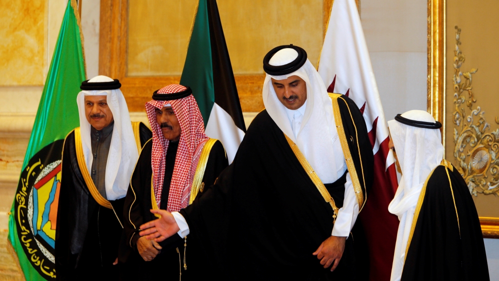 Emir of Qatar Sheikh Tamim bin Hamad al-Thani gestures as he poses for a family photo during the annual summit of the Gulf Cooperation Council (GCC), in Kuwait City