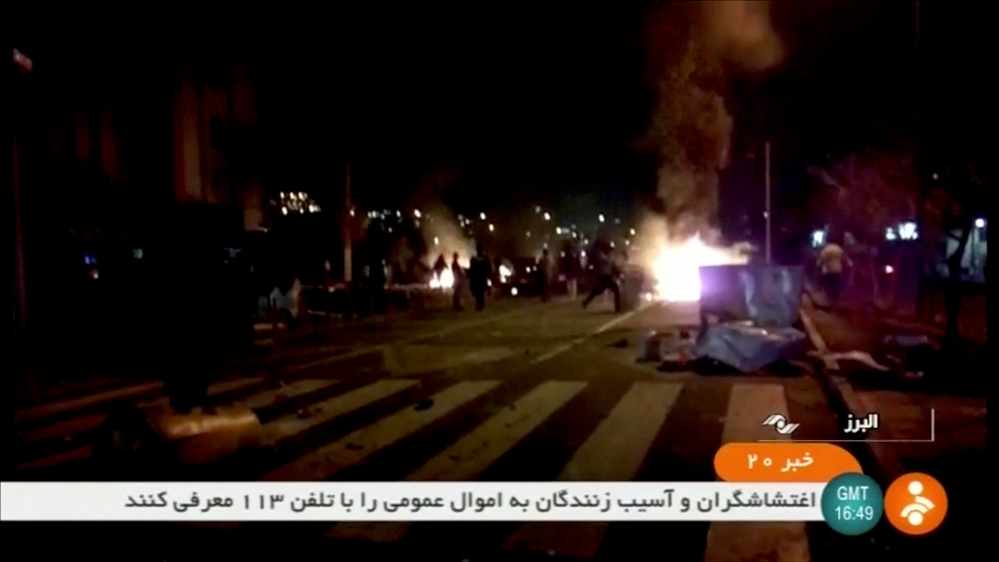 A still image taken from a video showing protesters in Tuyserkan on Sunday [Reuters]