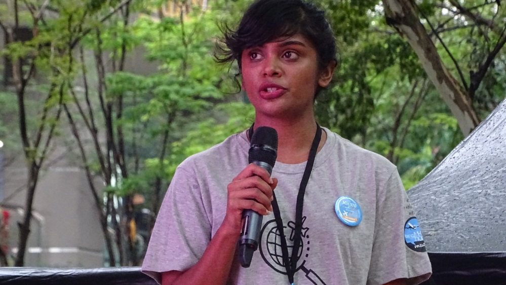 Grace Nathan, a lawyer in Kuala Lumpur, speaks at the remembrance event. Grace's mother was on the flight [Florence Looi/Al Jazeera]