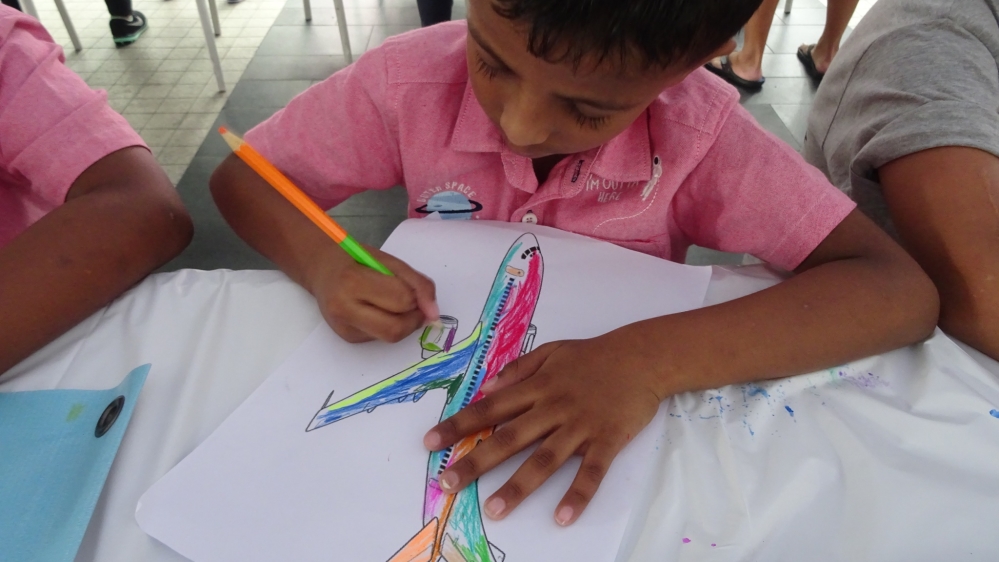 A colouring event marks four years since the disappearance of Malaysia Airlines flight MH370 [Florence Looi/Al Jazeera]