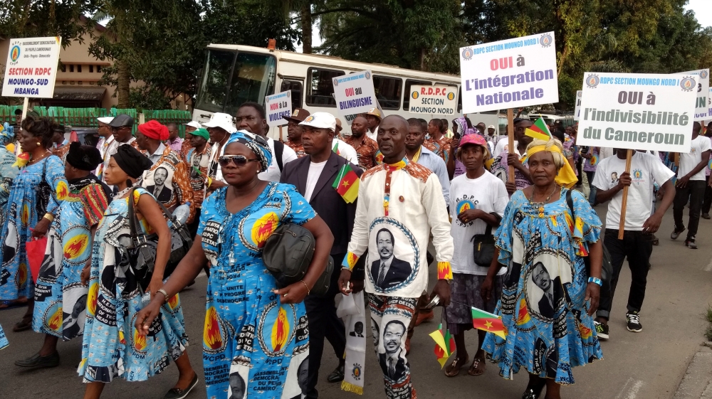 Demonstrators carry banners as they take part in a march voicing their opposition to independence or more autonomy for the Anglophone regions, in Douala