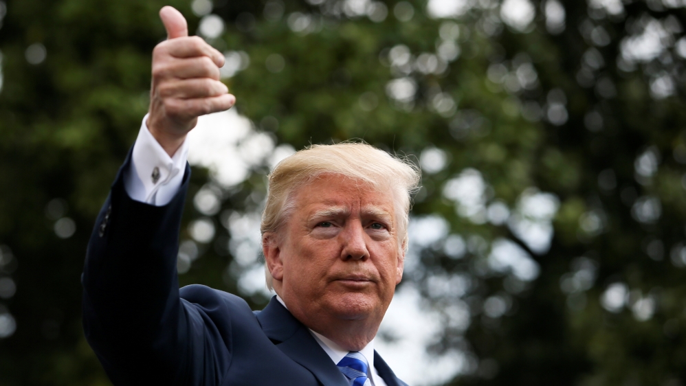 U.S. President Donald Trump gestures before boarding Marine One to travel to Texas from the South Lawn of the White House in Washington