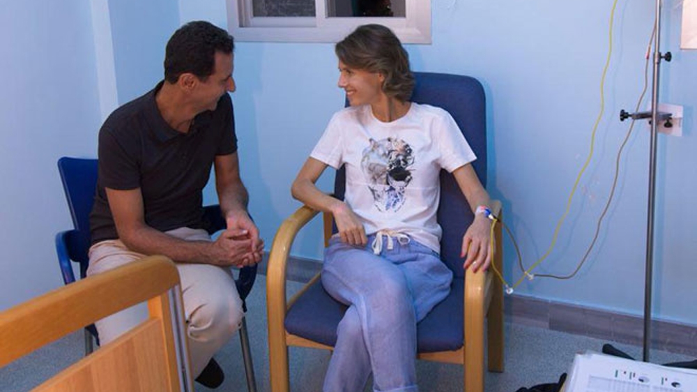 Syria's President Bashar al-Assad sits next to his wife, Asma Assad