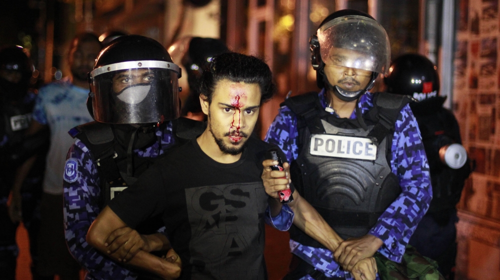 Police detain an injured opposition supporter during a protest demanding Maldives President Yameen Abdul Gayoom resign and jailed former president Mohamed Nasheed be freed, in Male, Maldives on May 1, 2015 [File: AP/Sinan Hussain]