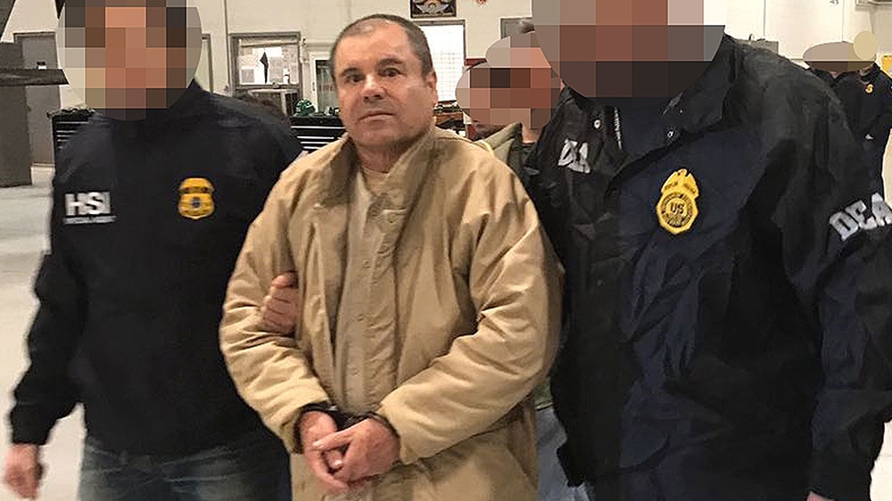Joaquin Guzman Loera aka 'El Chapo' Guzman is escorted in Ciudad Juarez by the Mexican police as he is extradited to the United States [File: Handout/Interior Ministry of Mexico/AFP] 