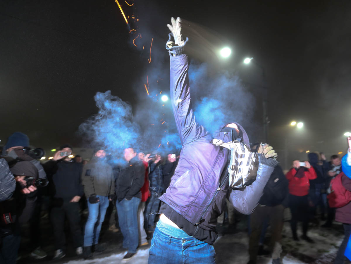 A protester throws a smoke grenade during a rally in front of the embassy of Russia in Kiev, Ukraine, Sunday, Nov. 25, 2018. Russia''s coast guard opened fire on and seized three of Ukraine''s vessels S