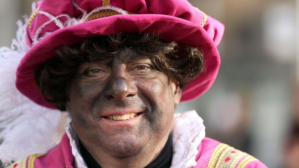 Protests against the tradition say the character is a racist portrayal of black people [Eva Plevier/Reuters]