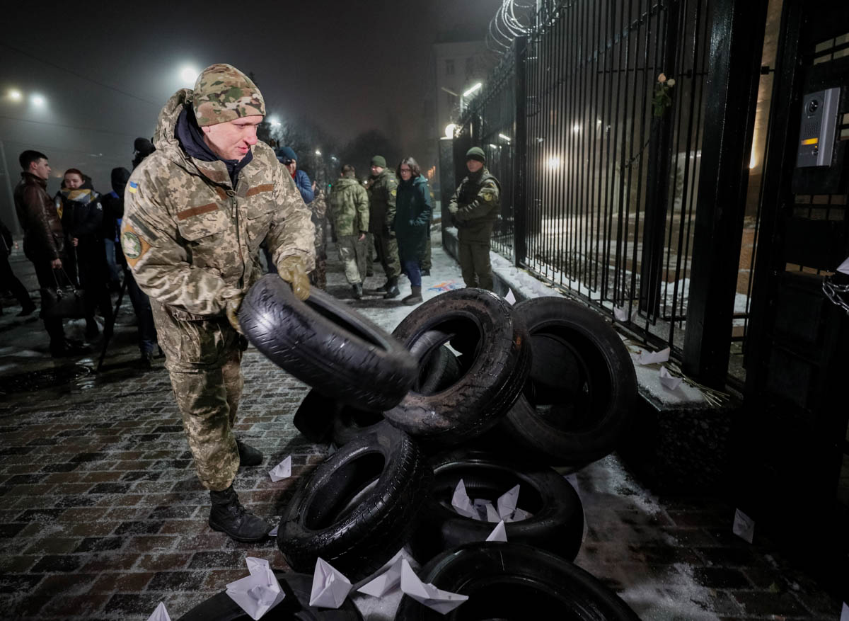 An activist piles up tires during a protest against the seizure by Russian special forces of three of the Ukrainian navy ships, which Russia blocked from passing through the Kerch Strait into the Sea