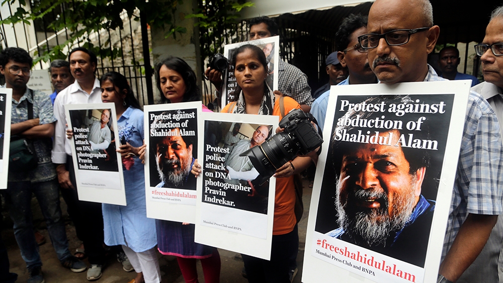 Indian journalists hold placards protesting against the attack on journalists and the arrest of Shahidul Alam, a renowned photographer and Bangladeshi activist as they gather outside Press Club in Mum