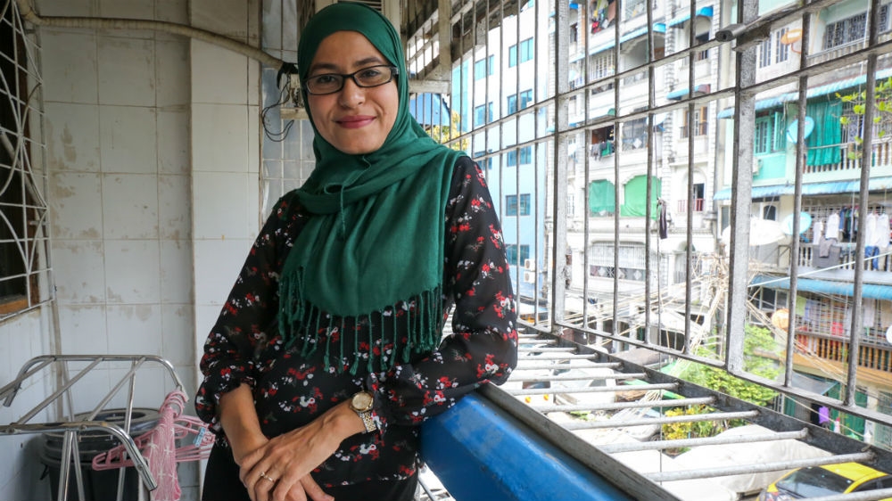 Dr Thet Htwe stands on the balcony of the Strong Flowers centre in Yangon [Victoria Milko/Al Jazeera]