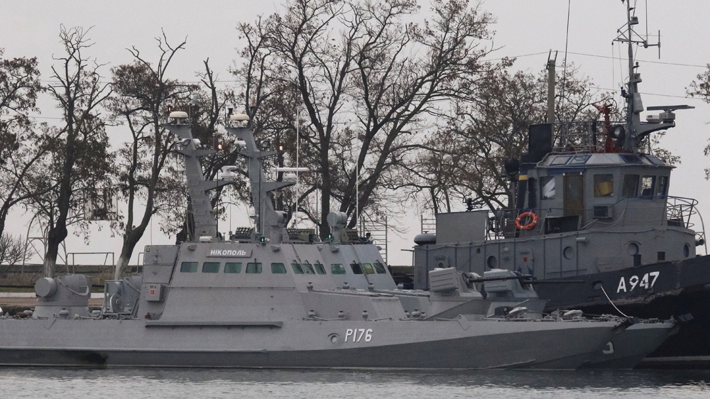 Seized Ukrainian ships are seen anchored in a port of Kerch, Crimea on Monday [Pavel Rebrov/Reuters]