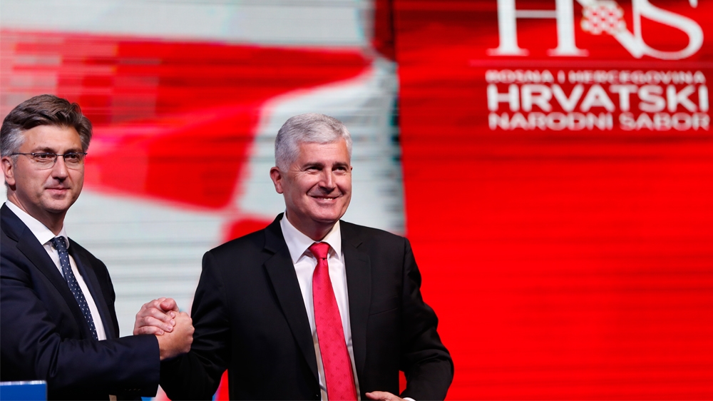 Croatia''s Prime Minister Andrej Plenkovic, left, shakes hands with Dragan Covic, presidential candidate of the Croatian Democratic Union (HDZ), during a political rally of the Croatian Democratic