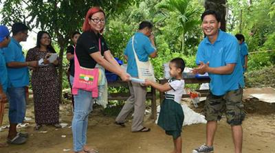 Wa Lone spent a lot of his free time doing charity work, including distributing books to children [Courtesy Yangon-based Youth Volunteers Network/Al Jazeera]