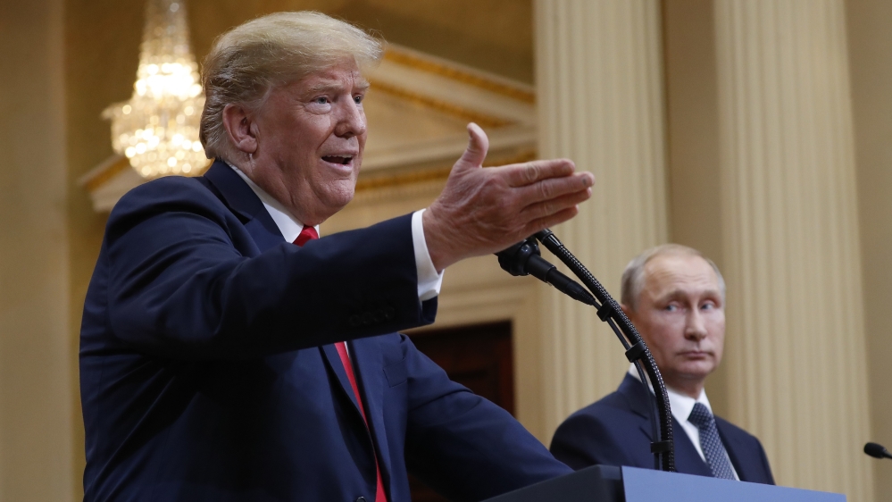U.S. President Donald Trump, left, gestures while speaking as Russian President Vladimir Putin