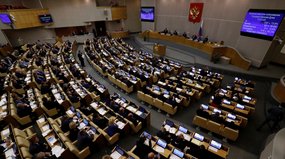 Russian lawmakers attend a session during a vote for the pension reform bill at the State Duma in Moscow