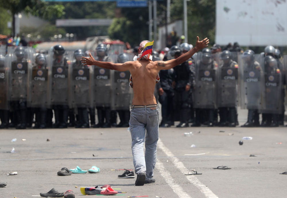 Opposition protesters face the Venezuelan Police at the Simon Bolivar International Bridge in Cucuta, Colombia, 23 February 2019. The Venezuelan Police prevented the passage of the humanitarian cordon