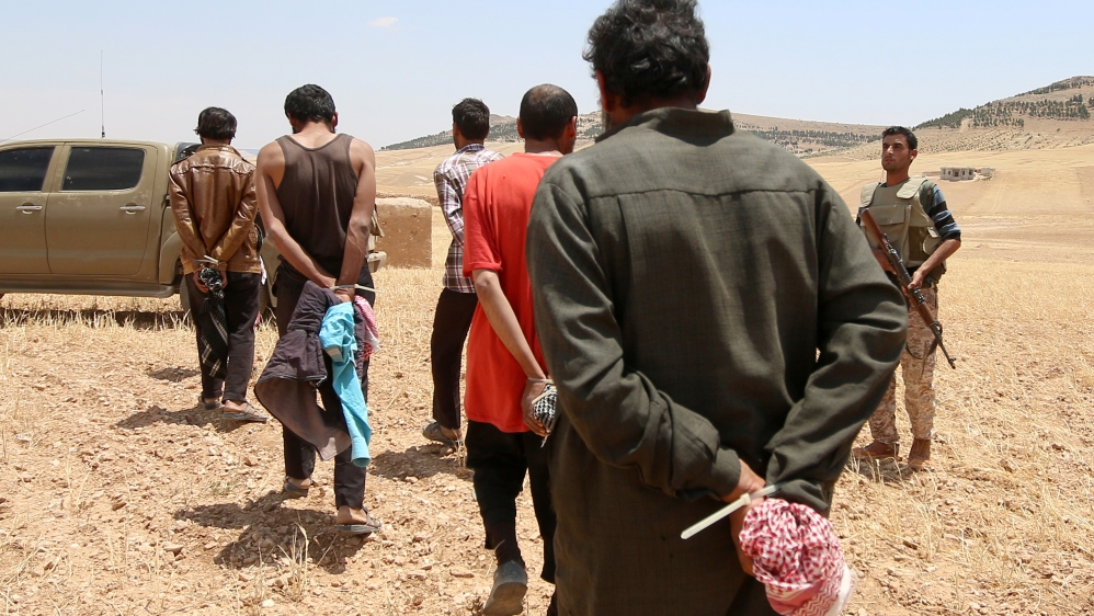 Suspected ISIL fighters being taken to prison