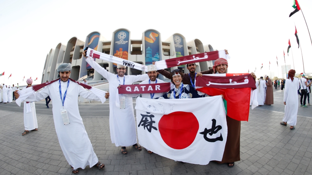 Japan and Qatar fans outside the stadium before the match [Thaier Al-Sudani/Reuters]