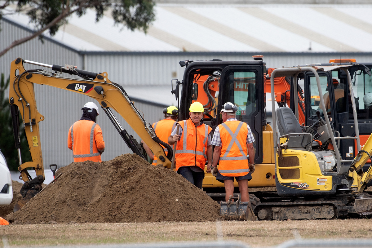 Workers dig grave sites at a cemetery in Christchurch on March 17, 2019 two days after a shooting incident at two mosques in the city. - New Zealanders flocked to memorial sites to lay flowers and mou