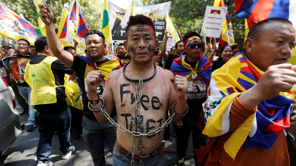 A Tibetan chains himself during a protest held to mark the 60th anniversary of the Tibetan uprising against Chinese rule, in New Delhi