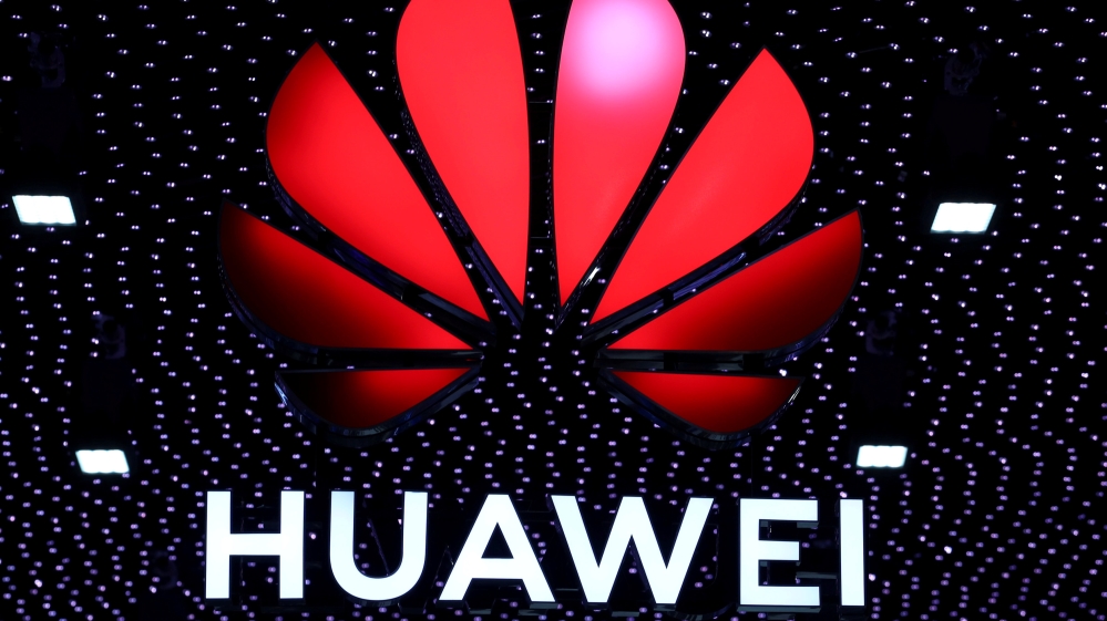 A 3D printed Huawei logo is placed on glass above a displayed U.S. flag in this illustration taken January 29, 2019