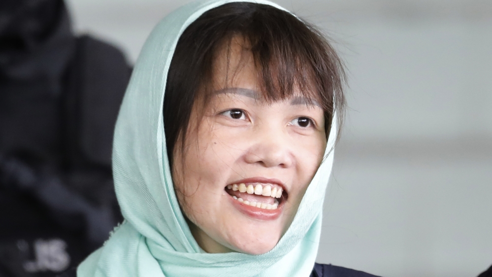 Vietnamese Doan Thi Huong, smiles as she is escorted by police as she leave Shah Alam High Court in Shah Alam, Malaysia, Monday, April 1, 2019. (AP Photo/Vincent Thian)