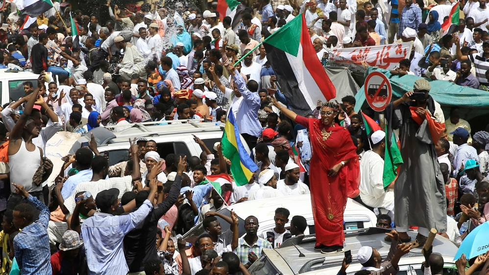Sudanese demonstrators protest against the army's announcement that al-Bashir would be replaced by a military-led transitional council [Reuters]