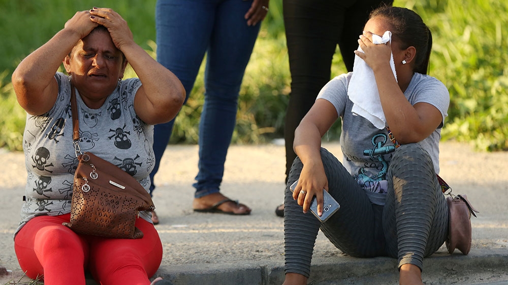 Relatives of inmates react in front of a prison complex in the Brazilian state of Amazonas