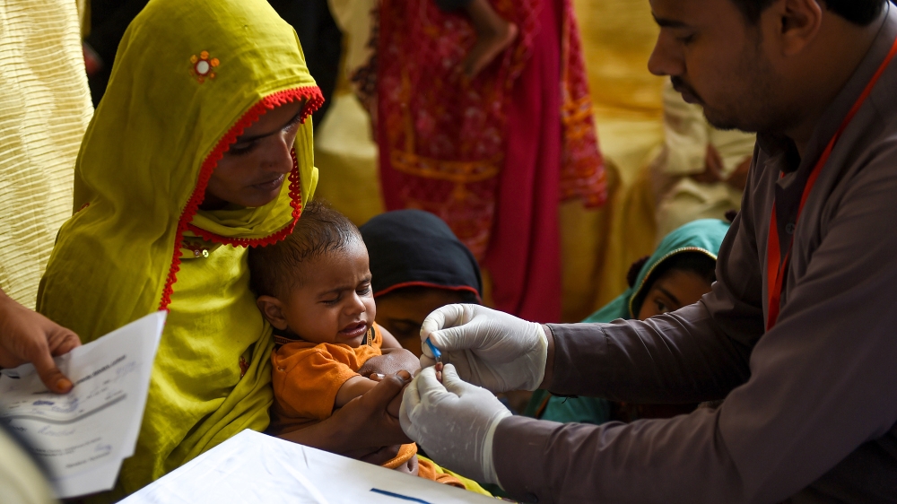 In this image taken on May 9, 2019, a Pakistani paramedic takes a blood sample from a baby for a HIV test at a state-run hospital in Rato Dero in the district of Larkana of the southern Sindh province
