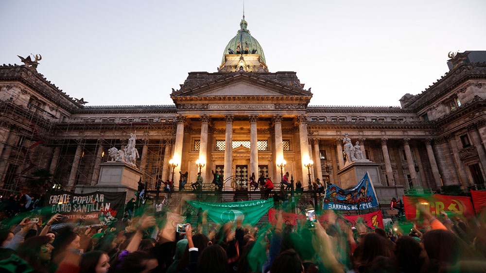 Activists with green handkerchiefs demonstrate to mark the revival of their campaign to legalize abortion, in front of the National Congress in Buenos Aires, on May 28, 2019