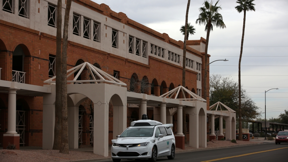 A Waymo Chrysler Pacifica Hybrid self-driving vehicle approaches during a demonstration in Chandler, Arizona