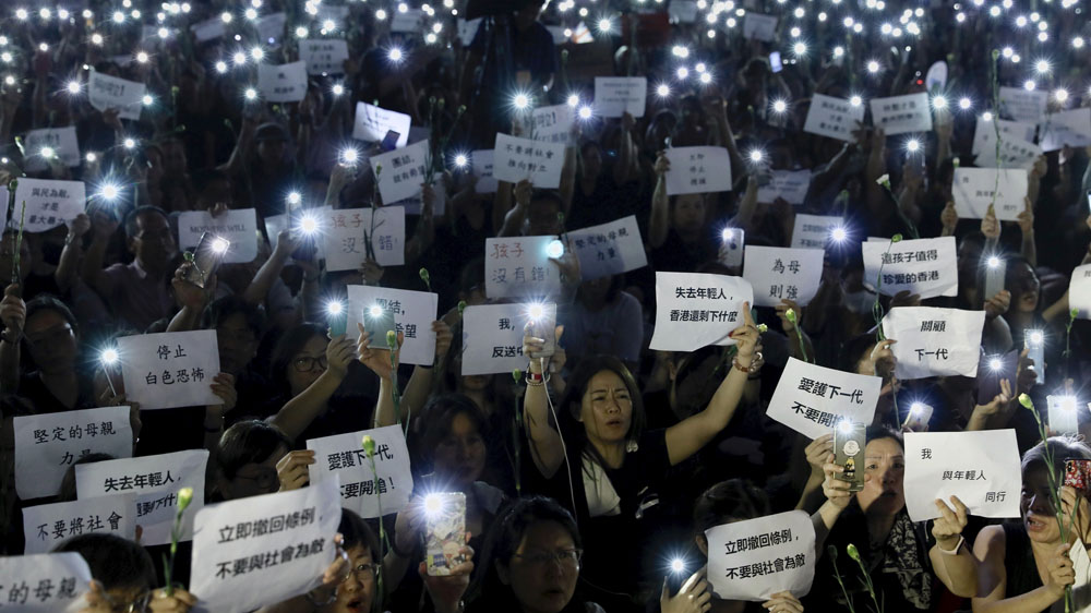 Hundreds of mothers protest against the amendments to the extradition law and activists say demonstrations will continue despite the suspension of debate